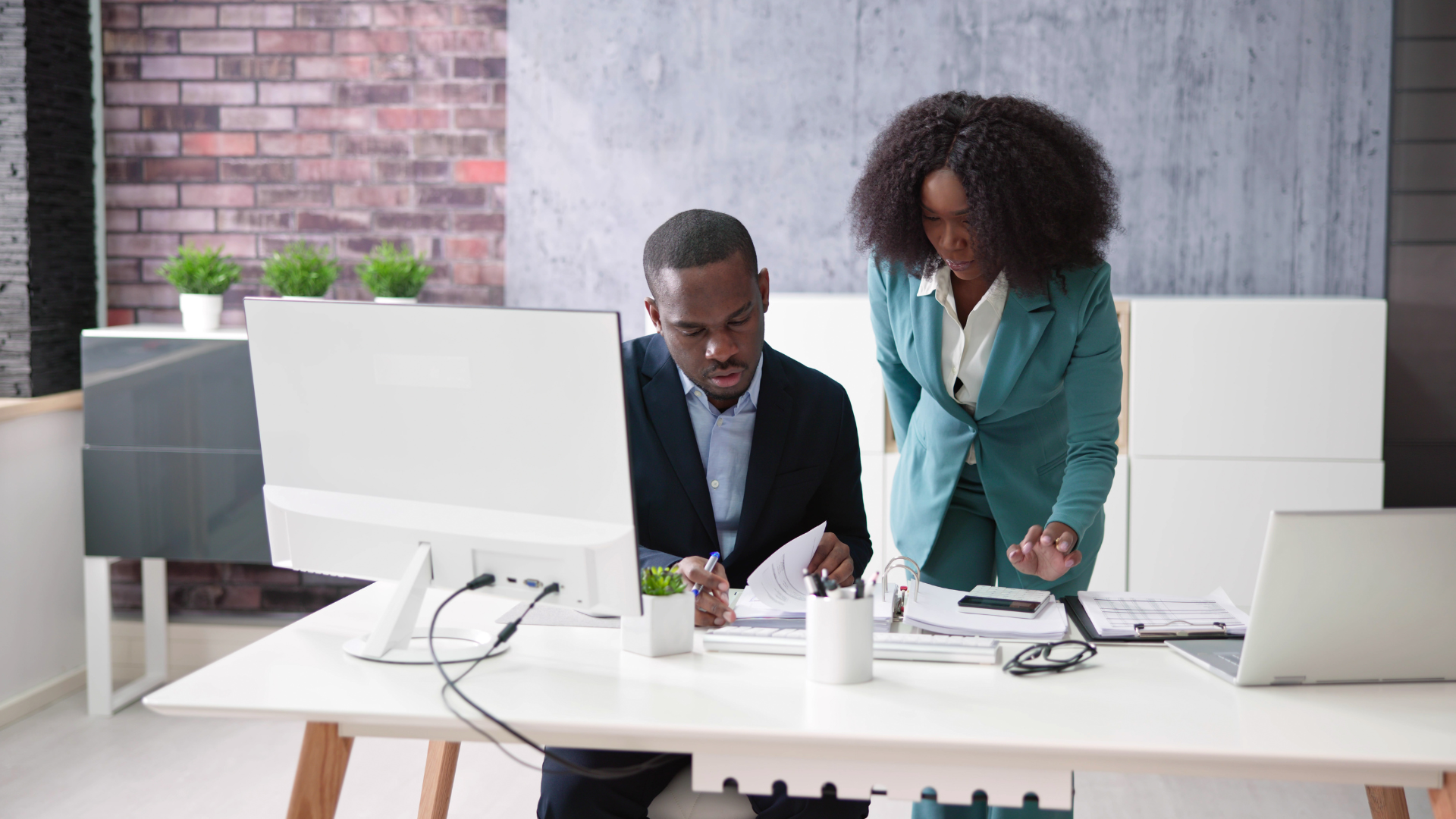 Two people looking at financial reports