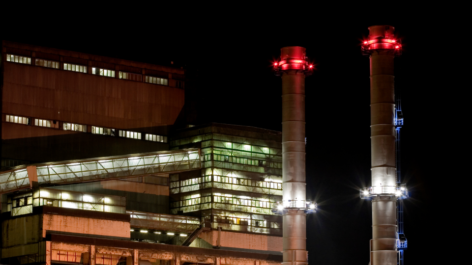 An image of factory chimneys at night