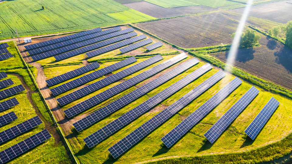 An aerial view of solar panel arrays in a field