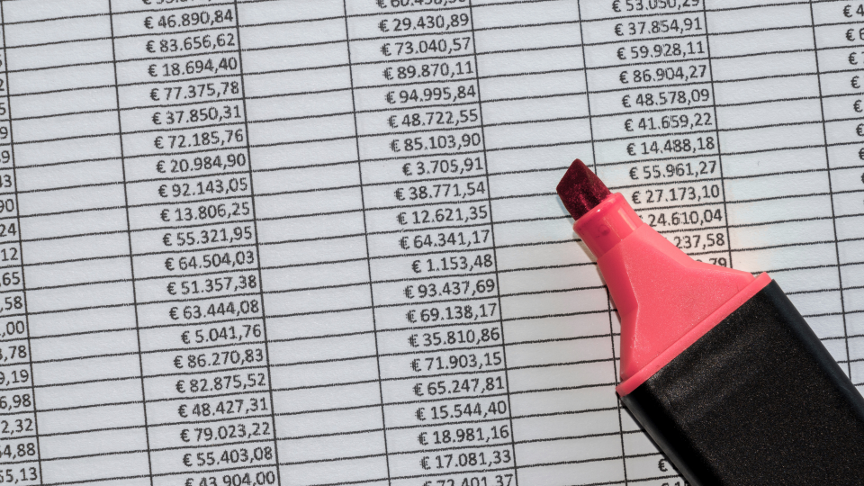 A close-up image of a table of data, with a red highlighter on top of it