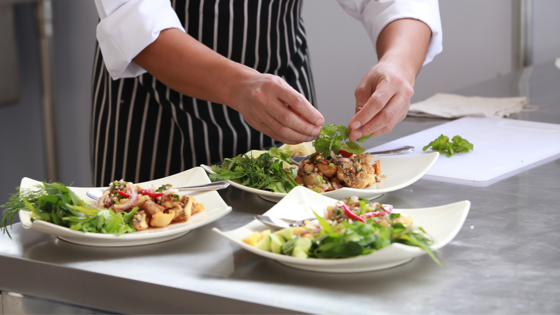 a chef adding garnishes to a dish