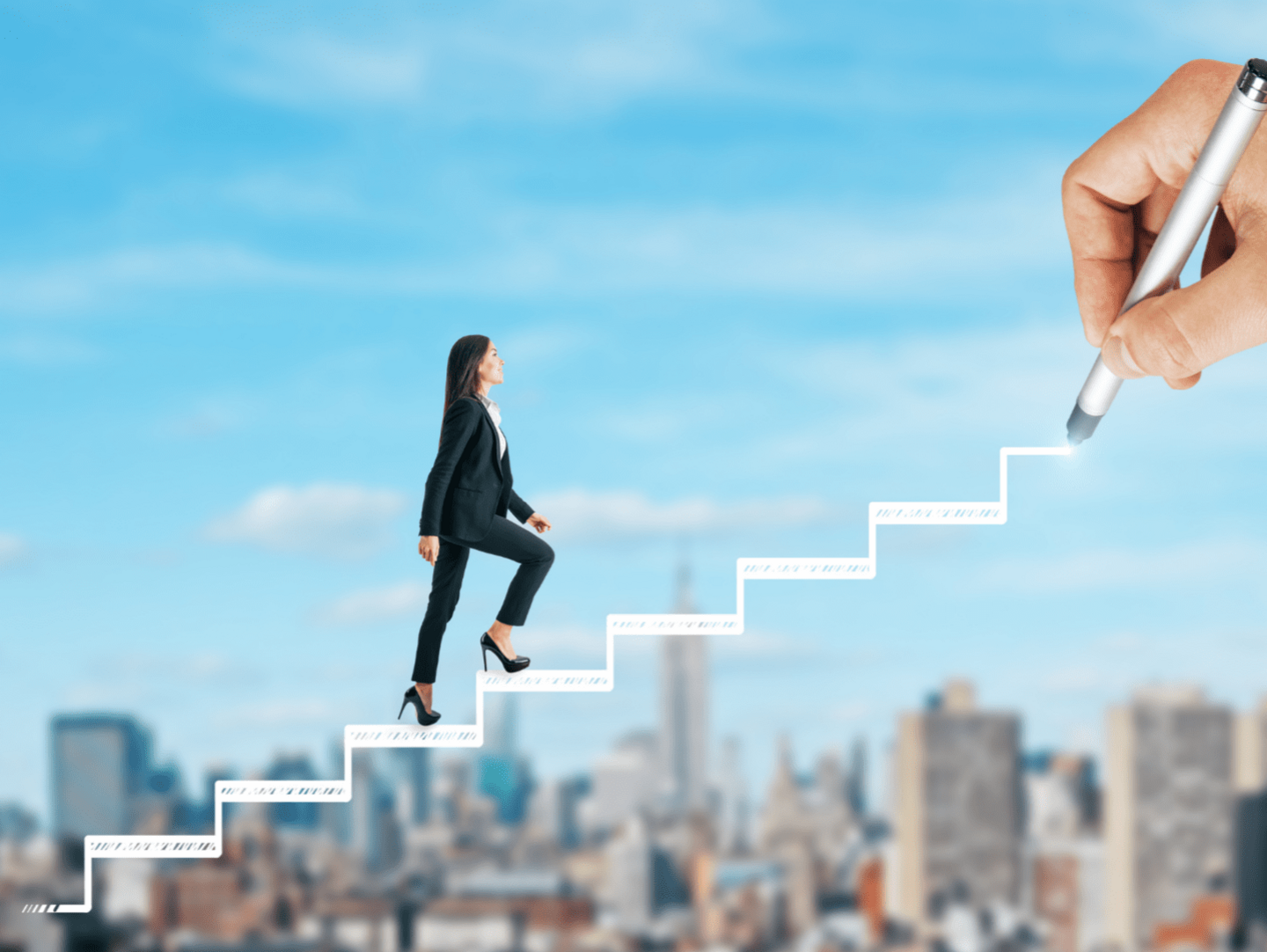 An image of a woman wearing black suit, walking up a staircase representing career growth