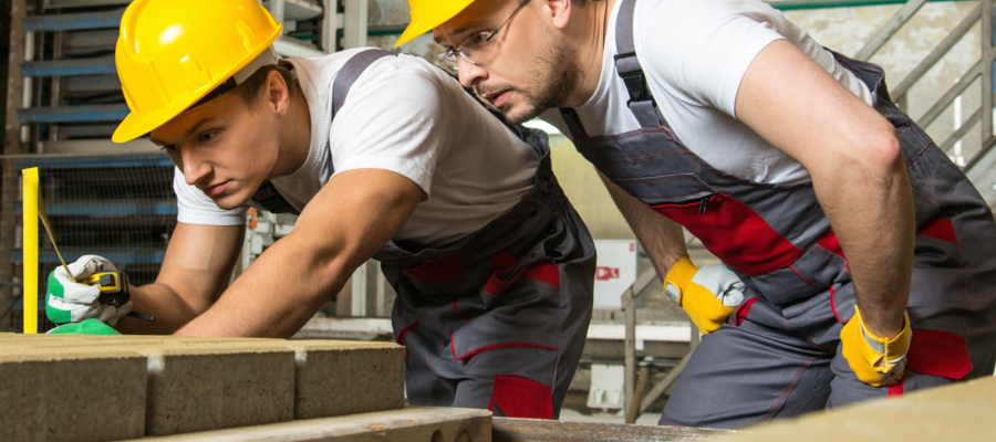 two builders laying bricks