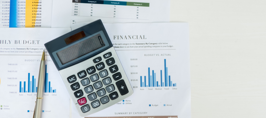 A calculator on top of financial documents