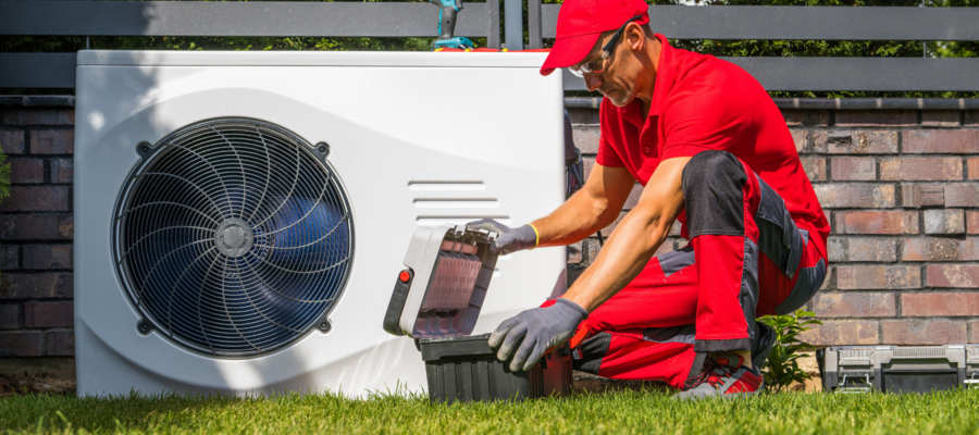 A heating engineer examining a heat pump