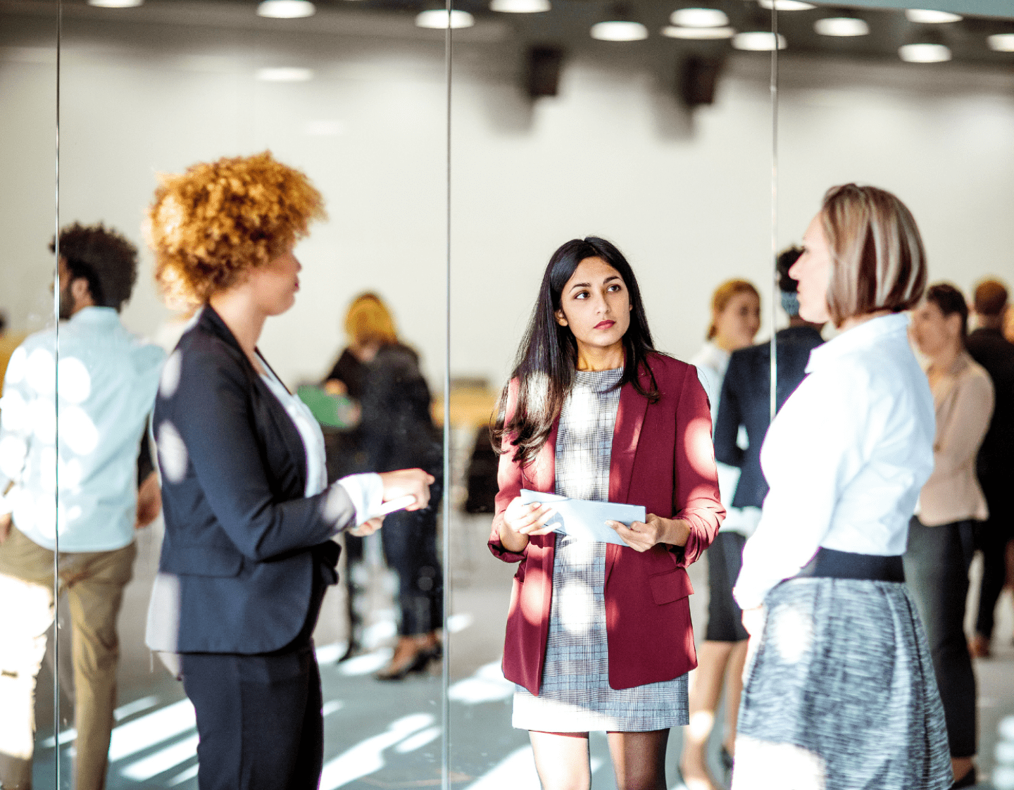 An image of three young professional women at an event