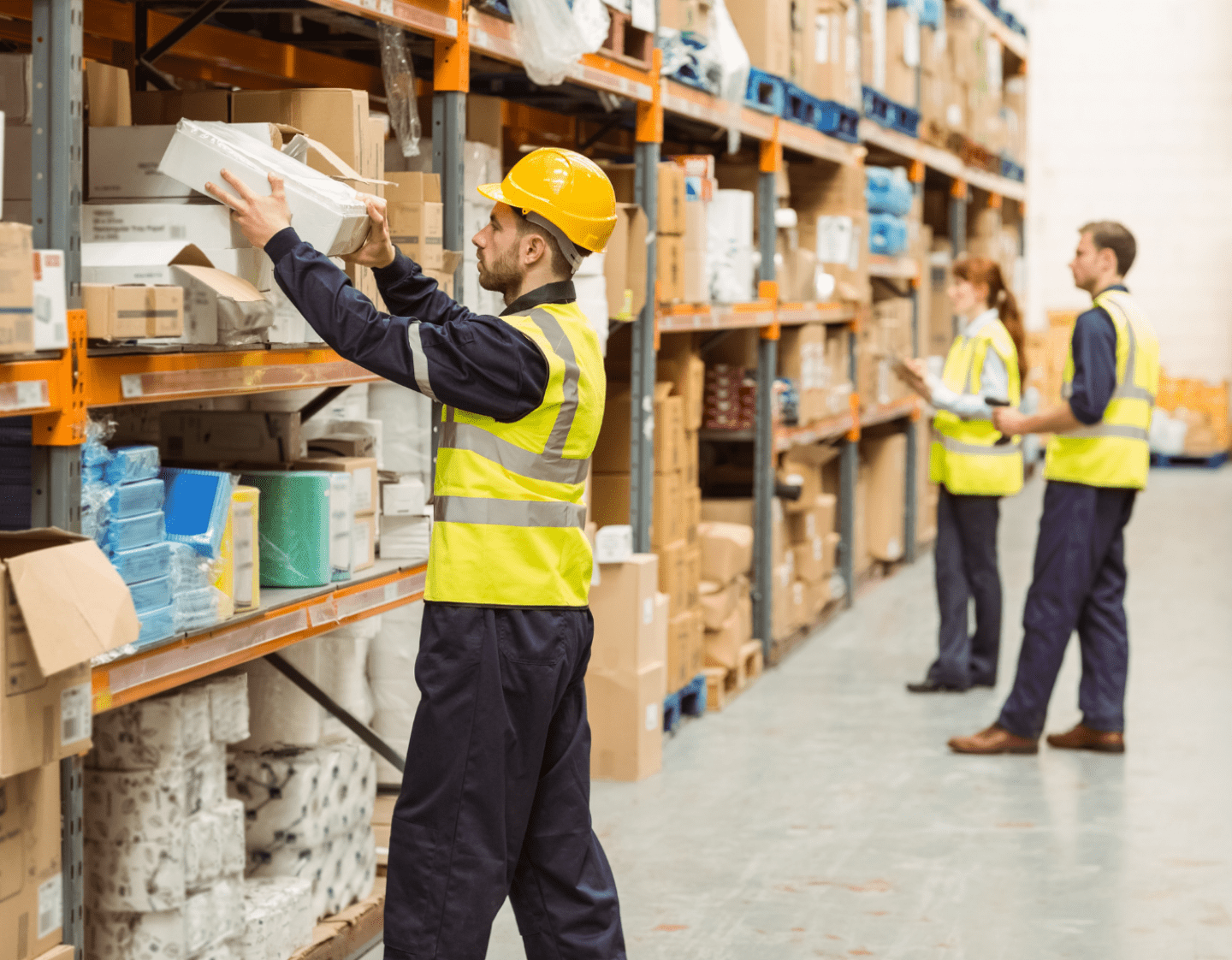 A warehouse worker picking a product from a shelf