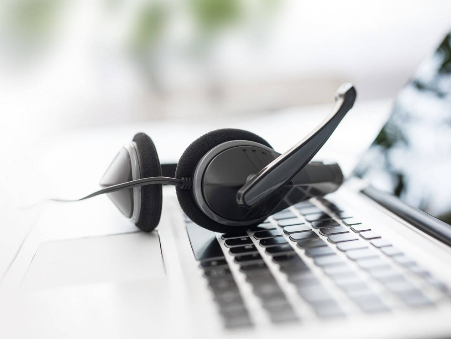 A headset with microphone on a laptop keyboard