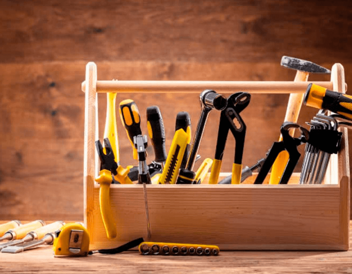 A wooden toolbox contain construction work tools