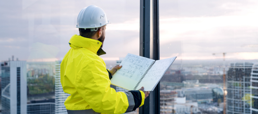 A man looking at a construction report